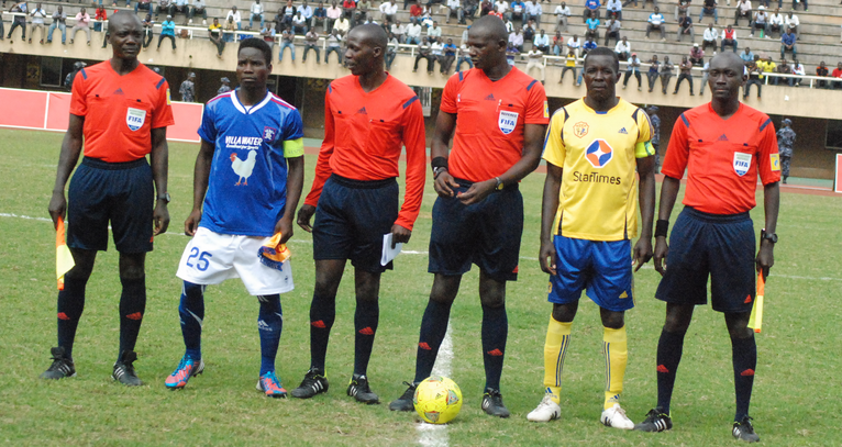 Kenyan referee, Oliver Omondi Odhiambo(football between his legs), was assisted by countrymen, Andrew Juma Otieno and Tony Mudayi Kidiya during the Uganda Cup final replay.